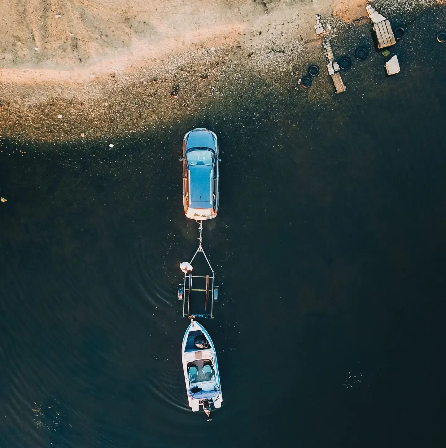Vehicle pulling boat trailer near water